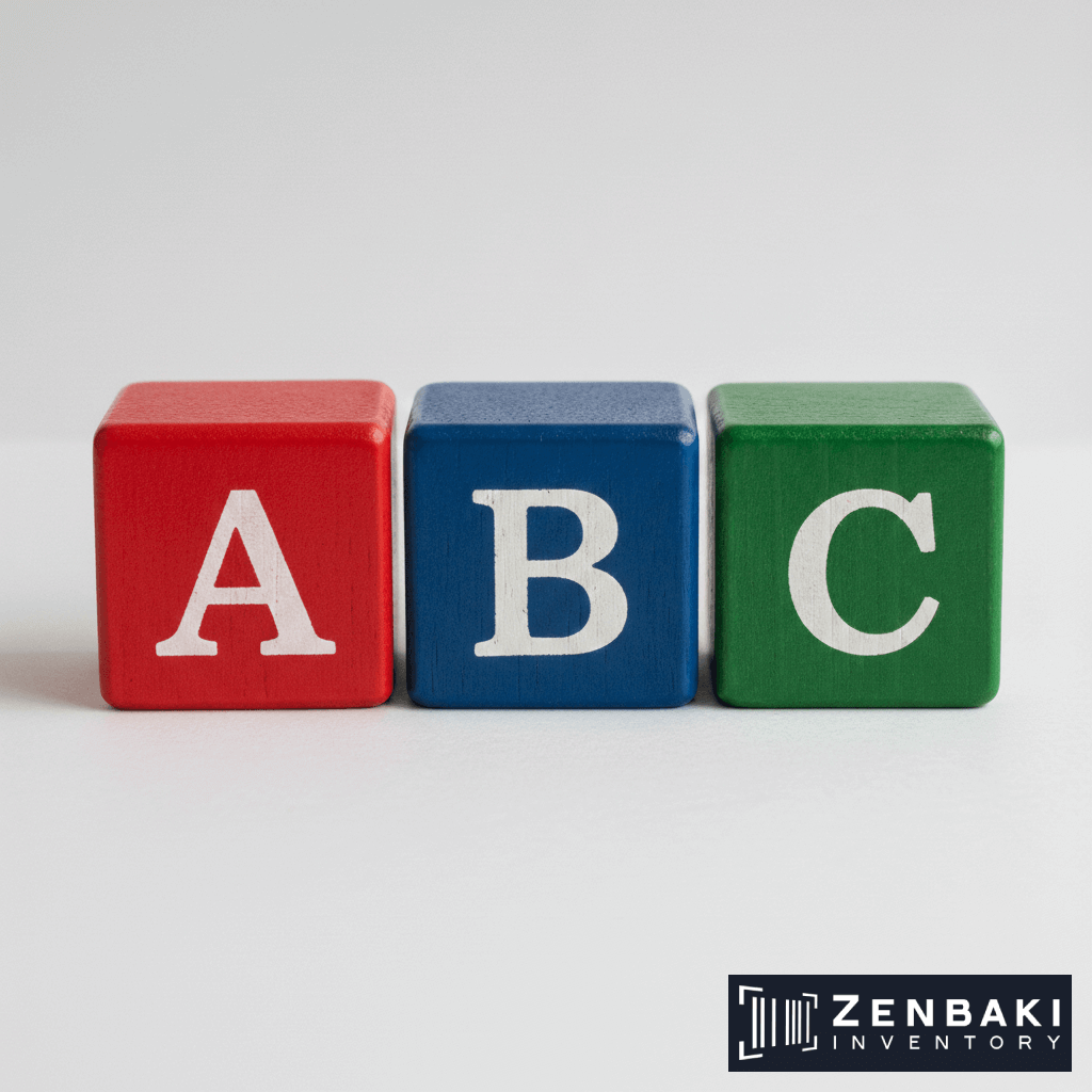 Three wooden blocks—red, blue, and green—display the letters A, B, and C, respectively. The Zenbaki Inventory logo is visible in the bottom right corner.